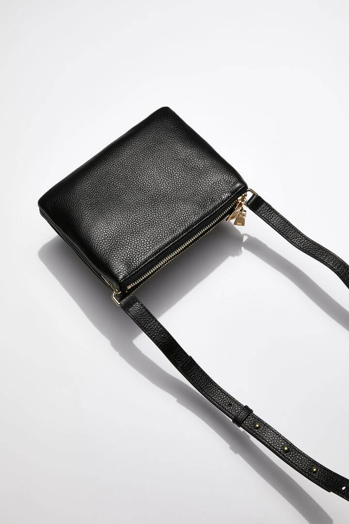 back view of MON Purses' double pouch bag in black pebbled leather with gold hardware with the long shoulder strap