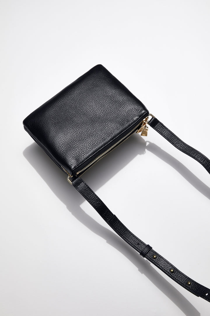 back view of mon purses' women's navy pebbled leather double pouch bag with gold hardware and long shoulder strap