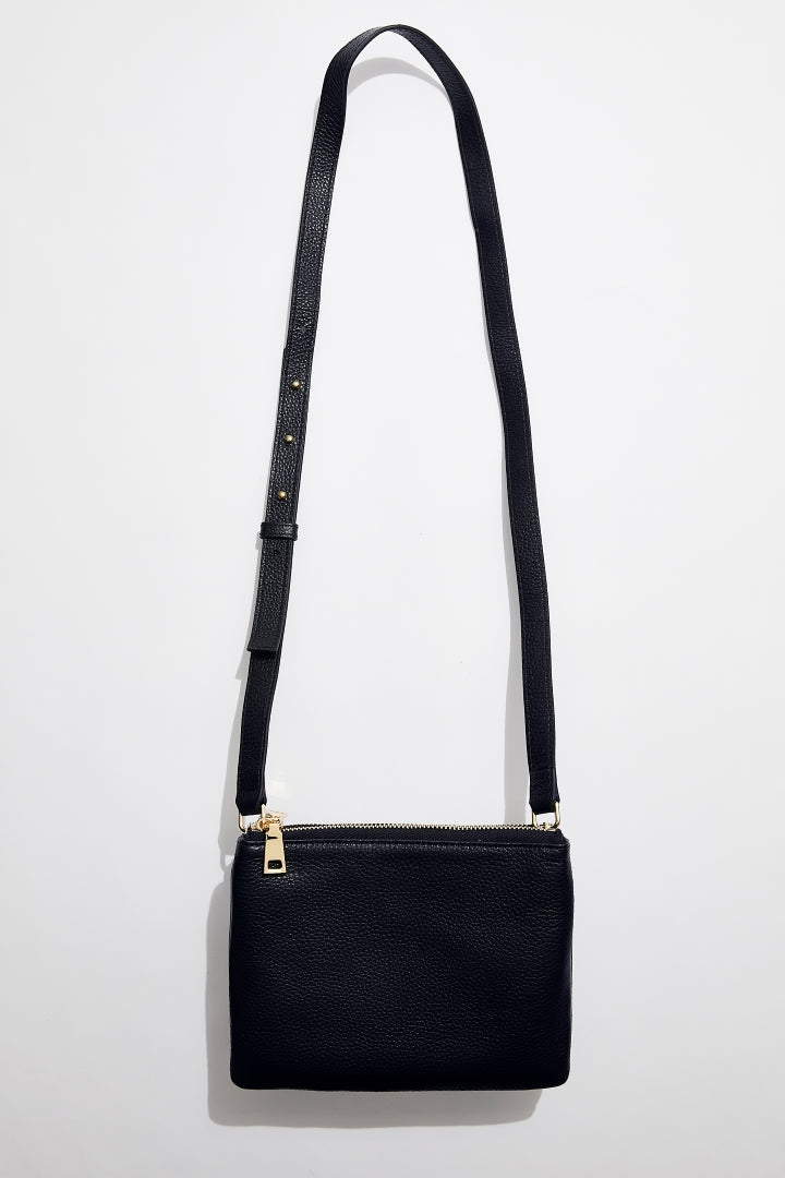 front view of mon purses' women's navy pebbled leather double pouch bag with gold hardware and long shoulder strap