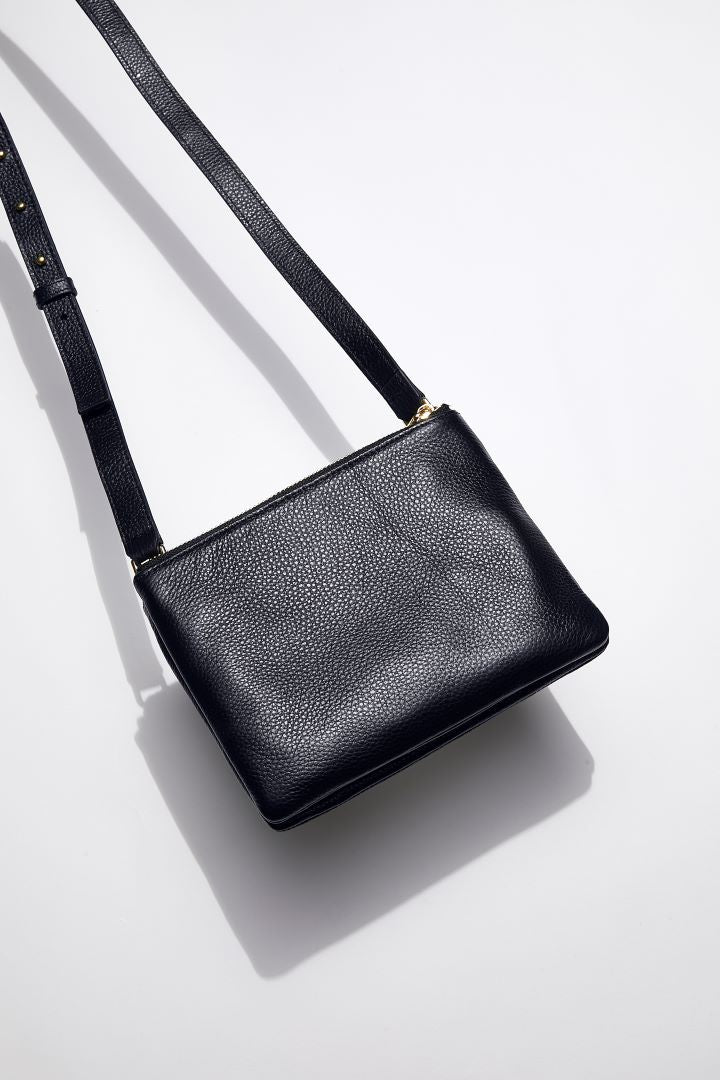 front view of mon purses' women's navy pebbled leather double pouch bag with gold hardware and long shoulder strap