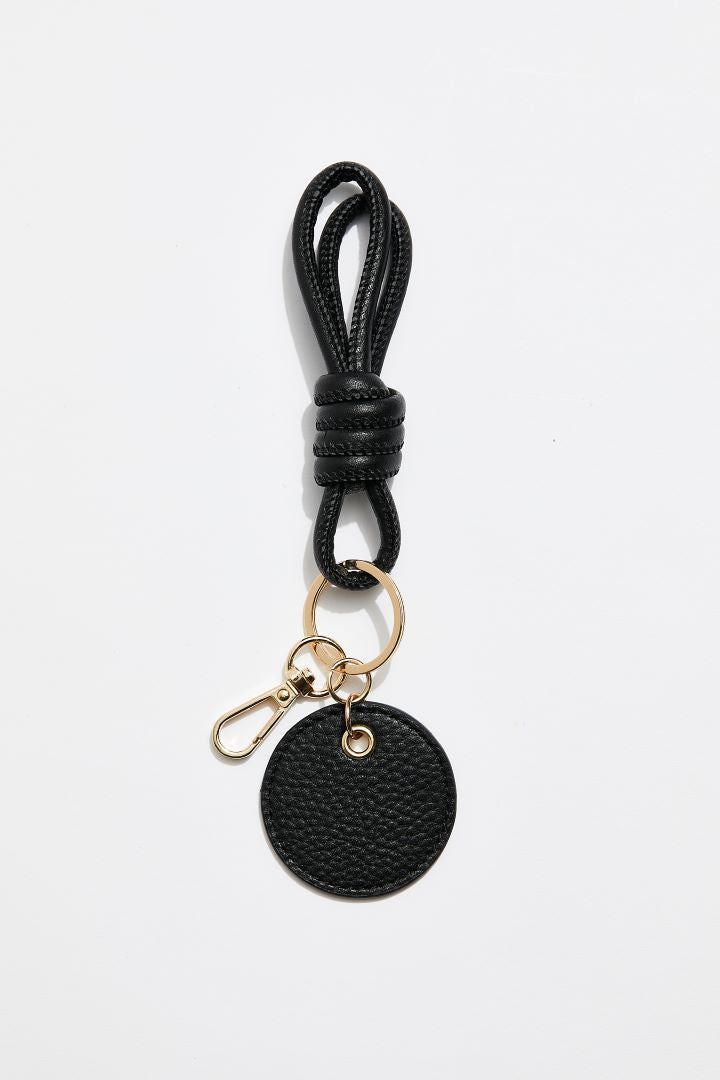 front view of MON Purses' black pebbled leather knotted keyring  that features a gold clasp to attach to the inside of your bag.