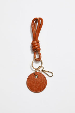 front view of MON Purses' camel pebbled leather knotted keyring that features a gold clasp to attach to the inside of your bag.