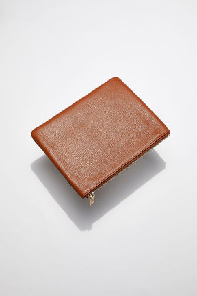 back view of MON Purses' tan pebbled leather pouch with gold zip closure