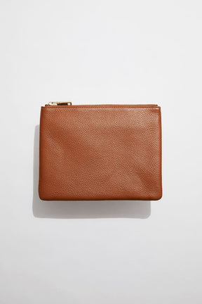 front view of MON Purses' tan pebbled leather pouch with gold zip closure