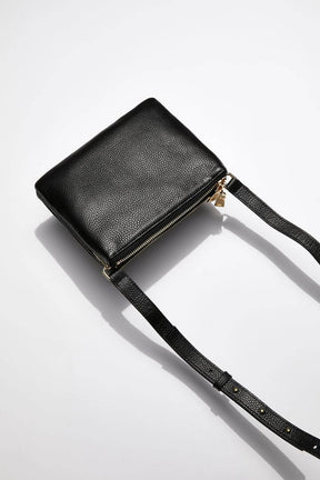 back view of MON Purses' double pouch bag in black pebbled leather with gold hardware with the long shoulder strap 