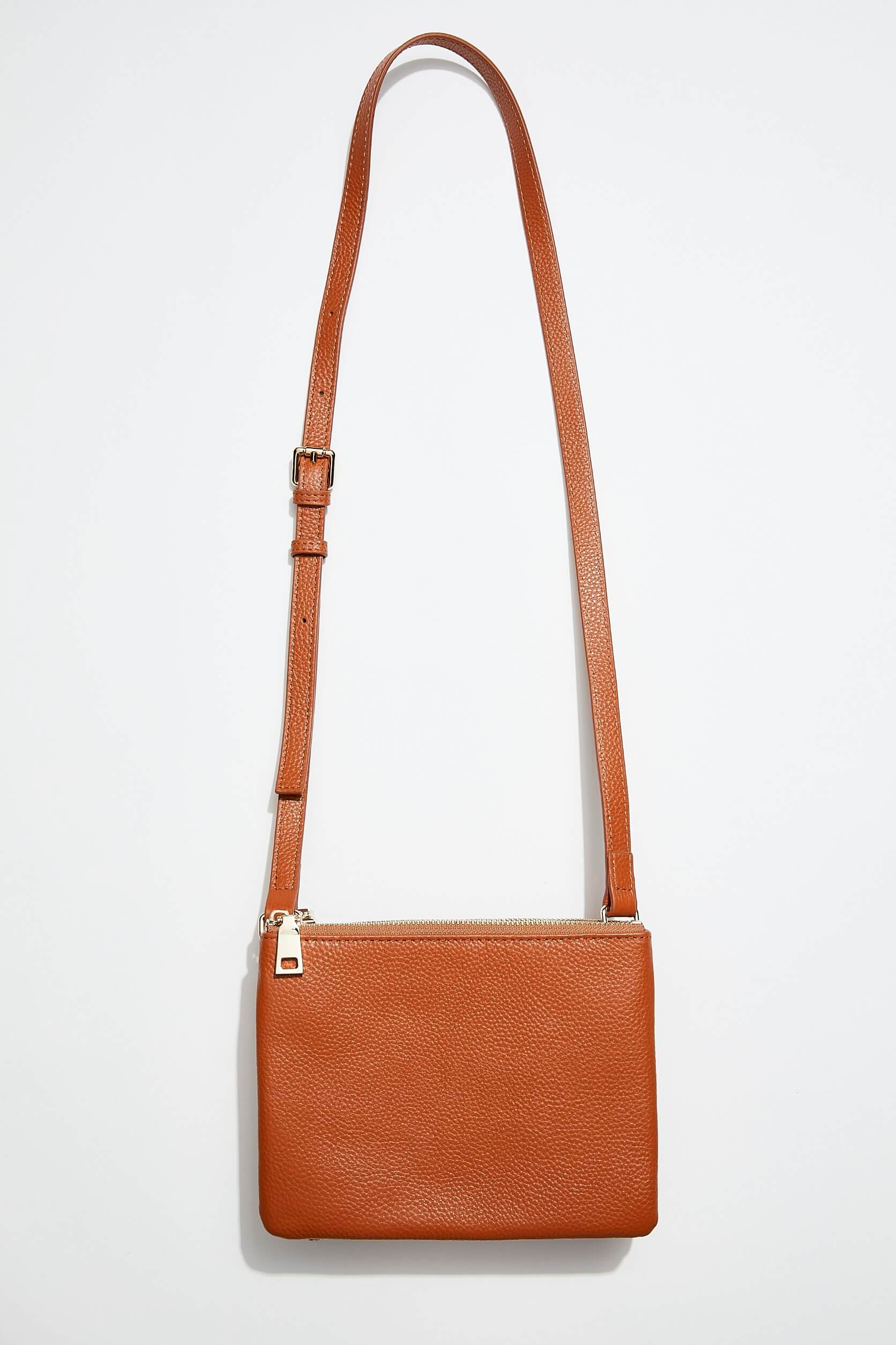 front view of mon purses' double pouch bag in camel pebbled leather with gold hardware with long shoulder strap showing interior of one of the pouches