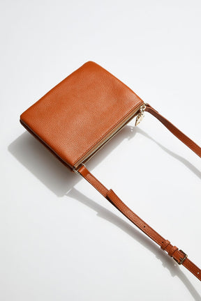 back view of mon purses' double pouch bag in camel pebbled leather with gold hardware with long shoulder strap