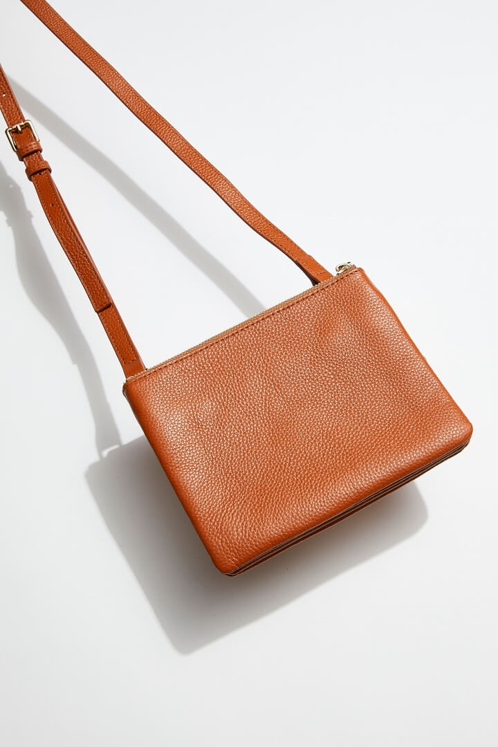 front view of mon purses' double pouch bag in camel pebbled leather with gold hardware with long shoulder strap
