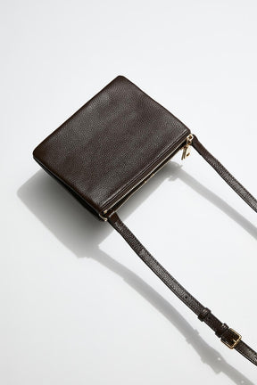 back view of mon purses' women's double pouch bag in chocolate brown pebbled leather and gold hardware with long shoulder strap