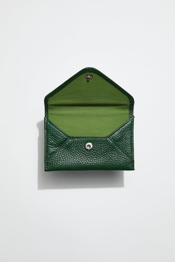 front view of mon purses dark green pebbled leather envelope card holder with the flap over to show interior 