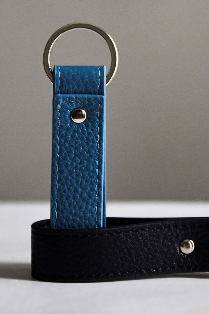 Stacked view of MON Purses' personalised black and sky blue pebbled leather Loop Keyring with silver hardware