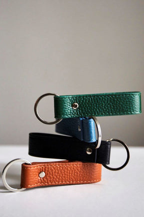 Stacked view of MON Purses' personalised black, dark green, camel and sky blue pebbled leather Loop Keyring with silver hardware