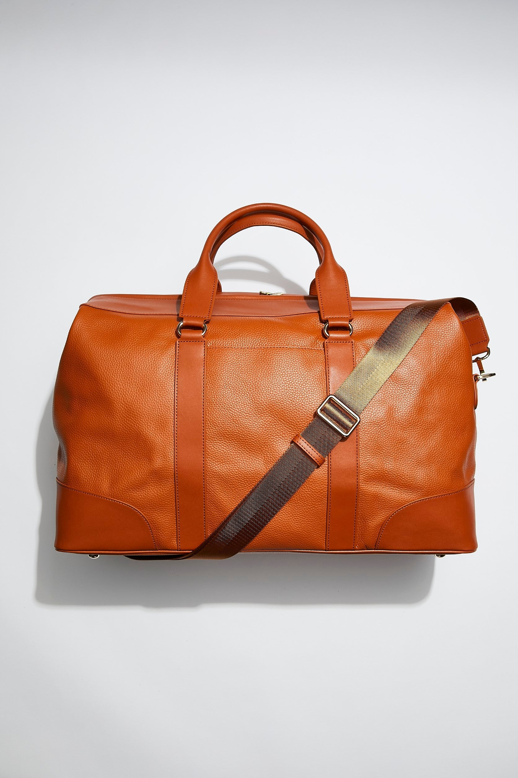 front view of mon purse's camel brown leather weekender bag that is large enough for weekends away and overnight stays