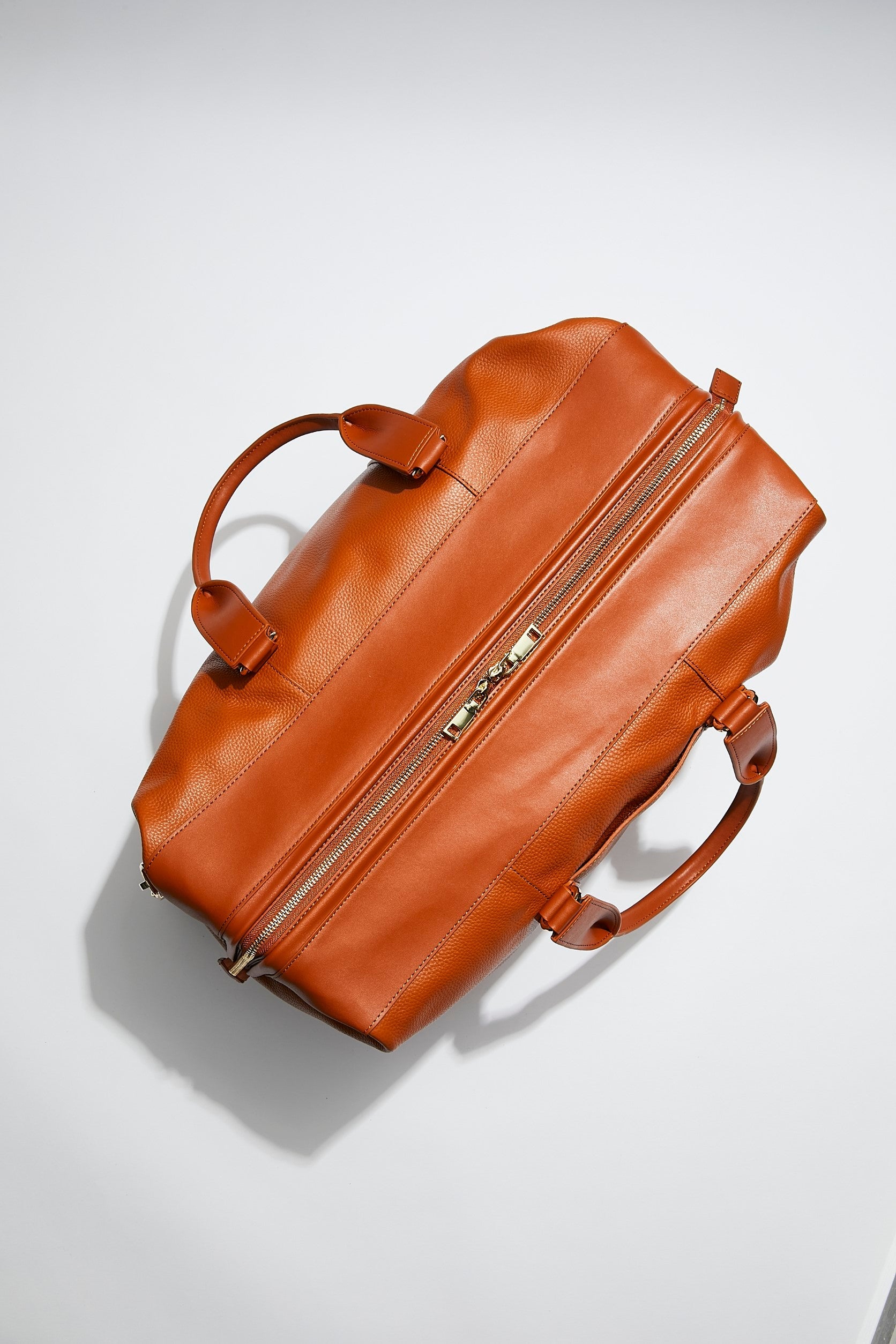 top view of mon purse's camel brown leather weekender bag that is large enough for weekends away and overnight stays