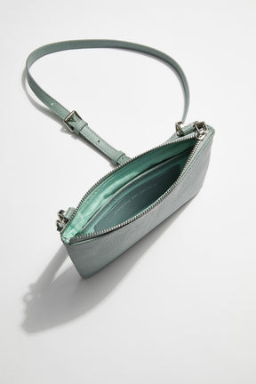 interior view of mon purse's sage green pebbled leather single pouch bag with sage green lining and slot pocket