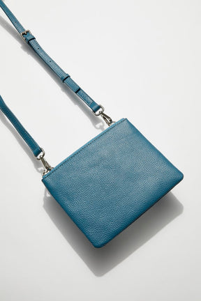 front view of mon purse's sky blue pebbled leather single pouch bag