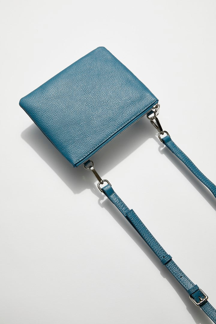 back view of mon purse's sky blue pebbled leather single pouch bag