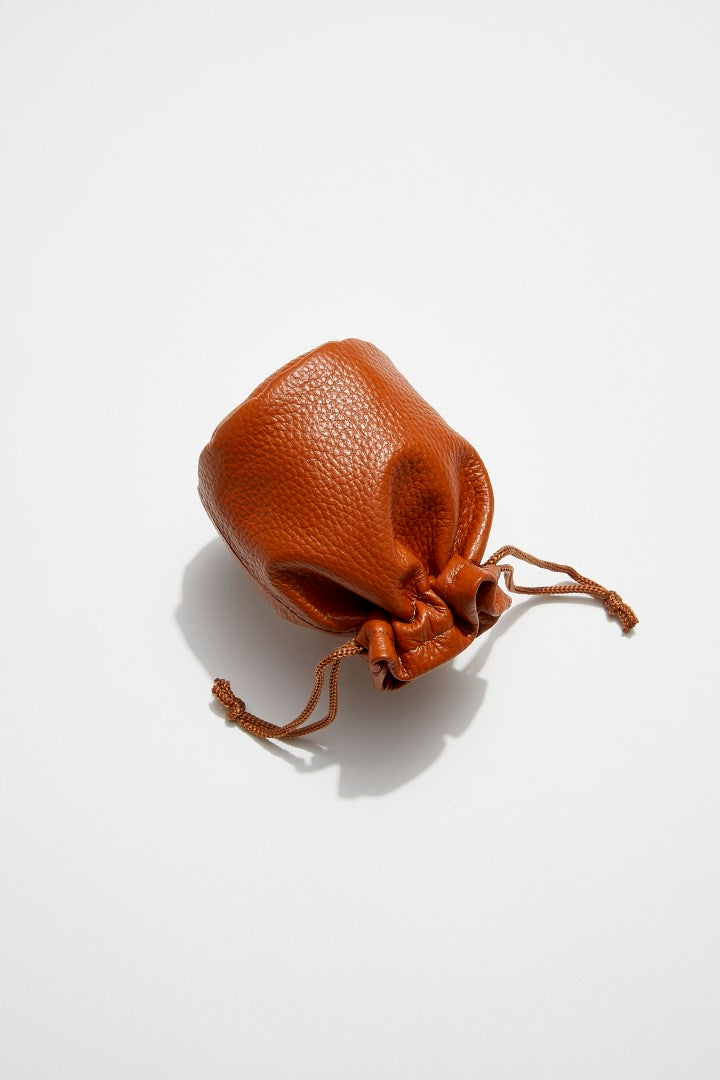 back view of mon purse's camel brown pebbled leather trinket pouch with drawstring closure