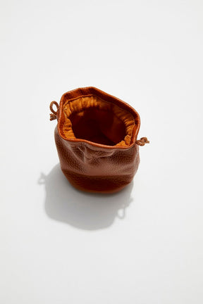 interior view of mon purse's camel brown pebbled leather trinket pouch with drawstring closure
